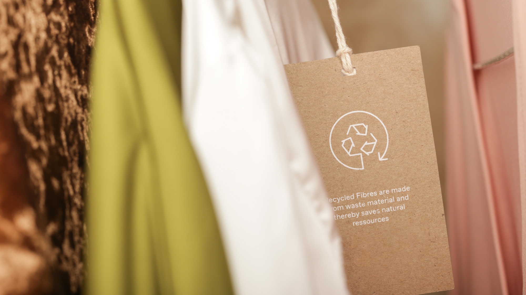 Close up of clothing tag with recycle icon